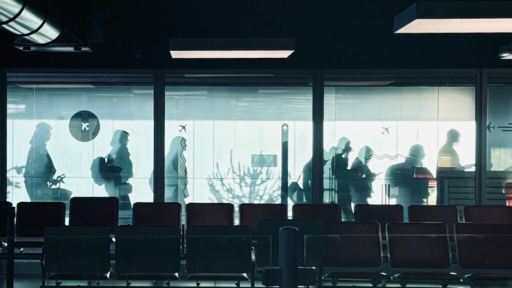 A group of people standing in front of a window